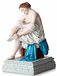 Gardner bisque porcelain figure. Young nude woman adjusting her stockings.